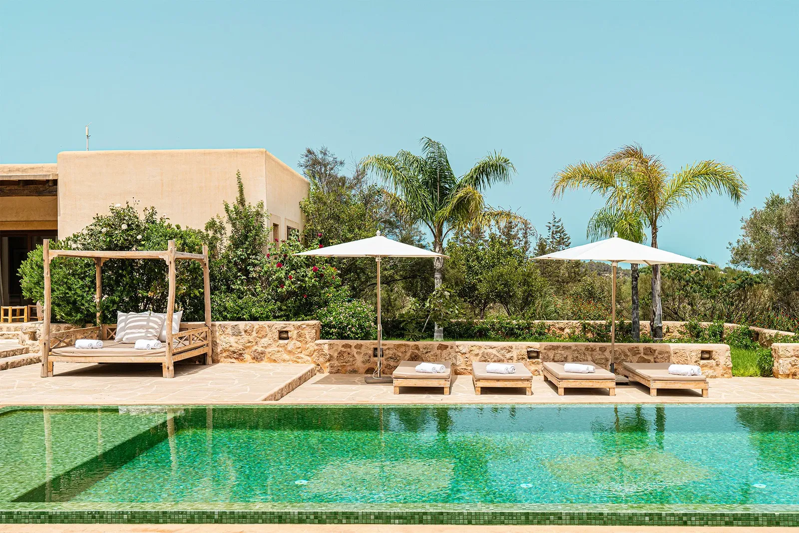 Privézwembad van Villa Jaia tussen palmbomen, Ibiza