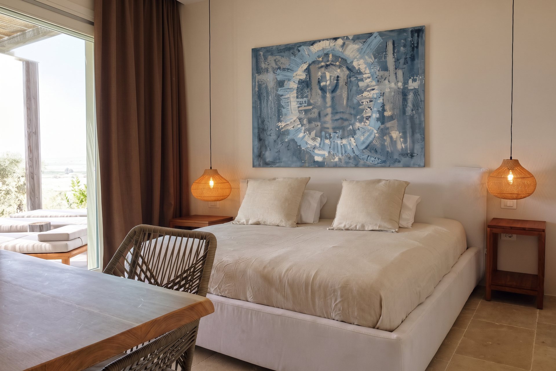 Bedroom with a woven rattan chair overlooking the olive grove
